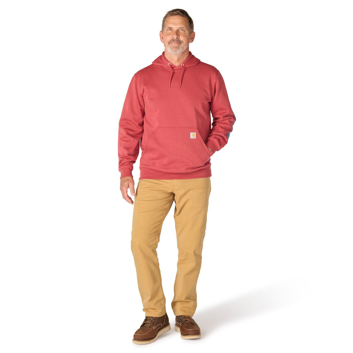 Man wearing a red hoodie and beige pants on a white background