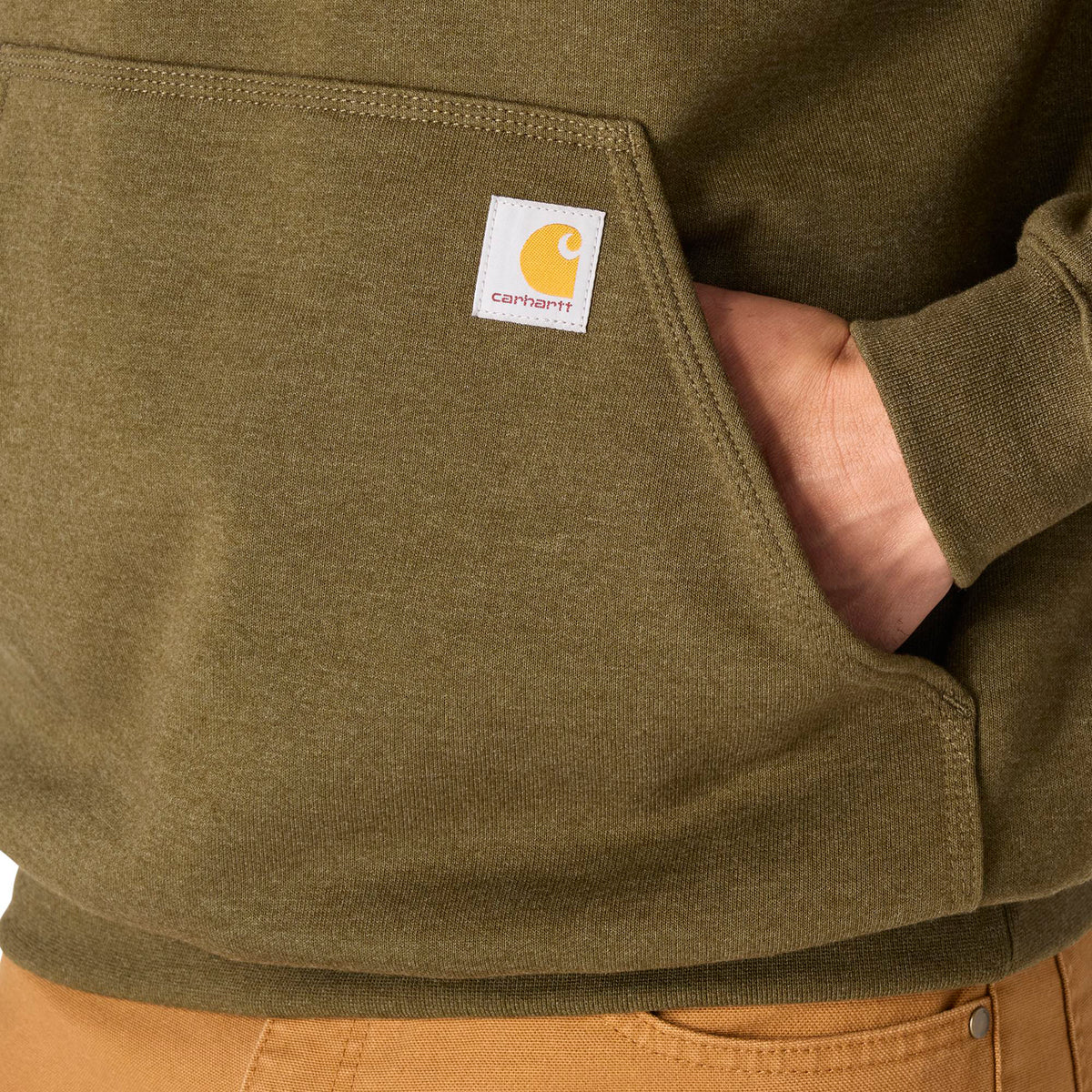 Close-up of a green Carhartt jacket with a visible brand logo.