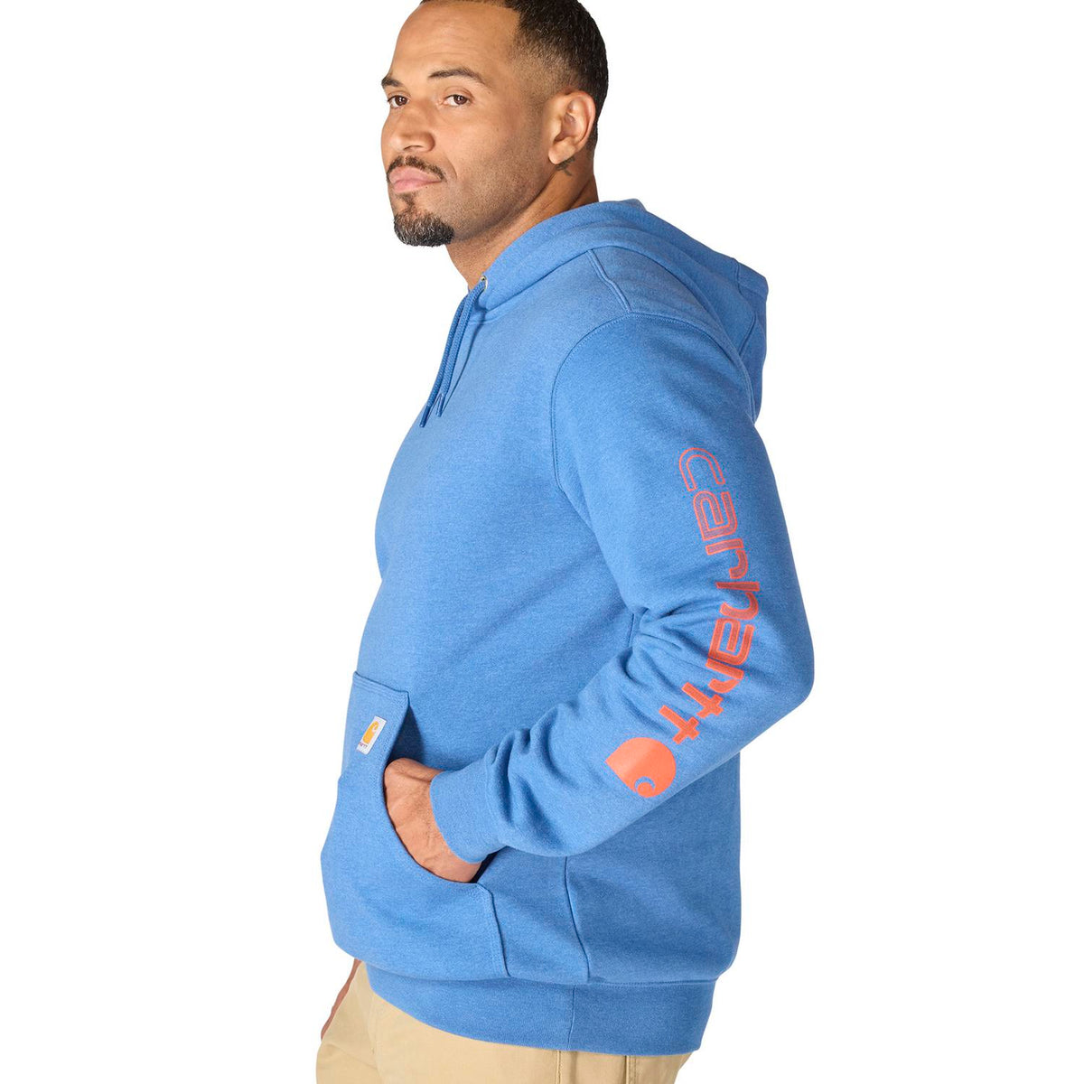 Man wearing a blue hoodie with orange text on a white background